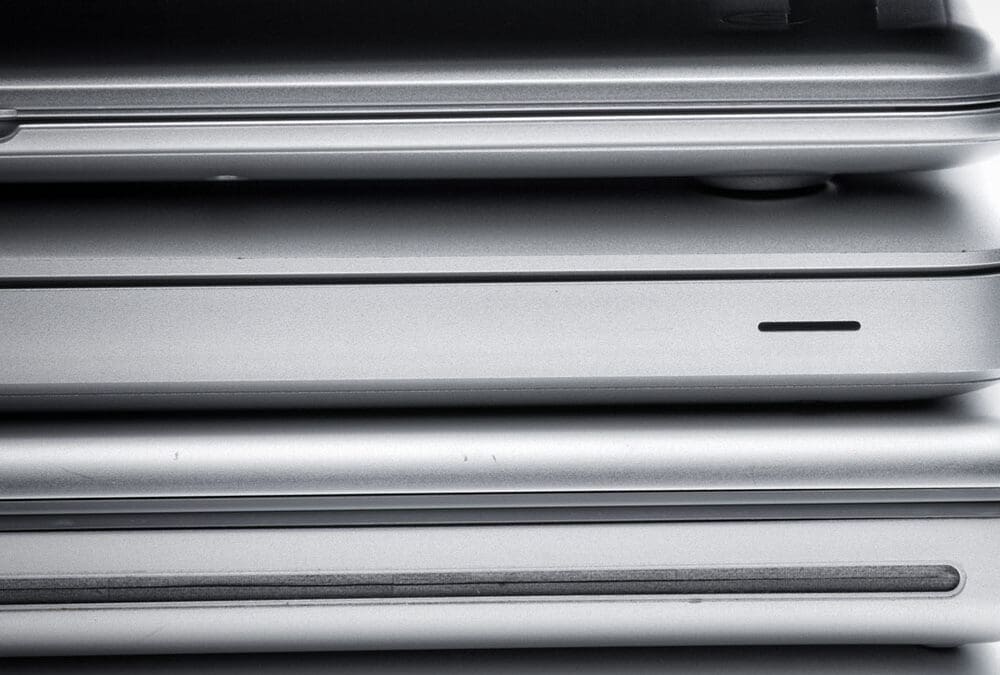 Stack of closed laptop computers viewed from the side